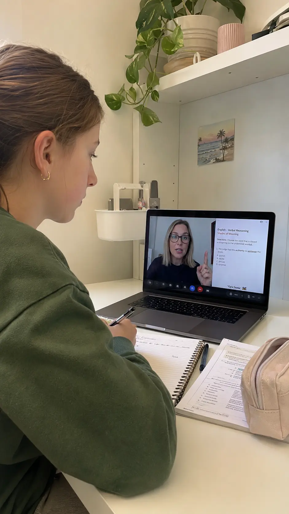 A pupil taking notes during a live online lesson